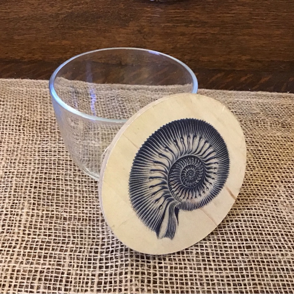 Glass container with wooden lid.  Navy shell design.